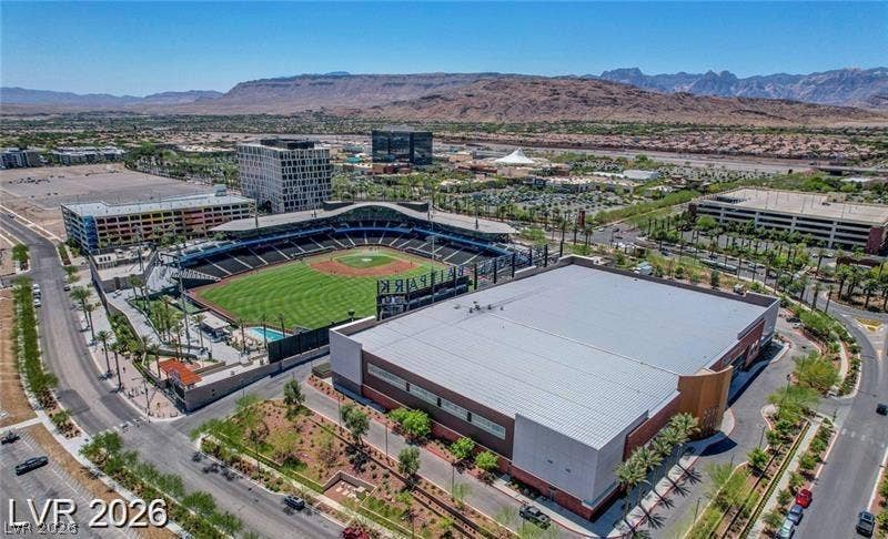 Downtown SUMMERLIN sports stadium, expansive valley, and rugged mountain ridges.