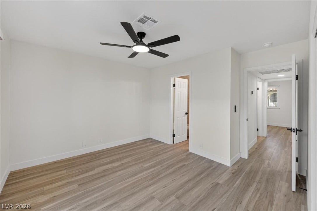 4454 W Desert Inn Road, #D, Las Vegas, NV 89102 Smooth wood-style flooring and neutral walls define this inviting bedroom space.
