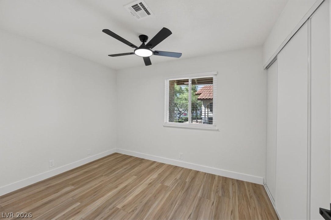 4454 W Desert Inn Road, #D, Las Vegas, NV 89102 Smooth wood-style flooring and a bright window elevate this versatile secondary bedroom.