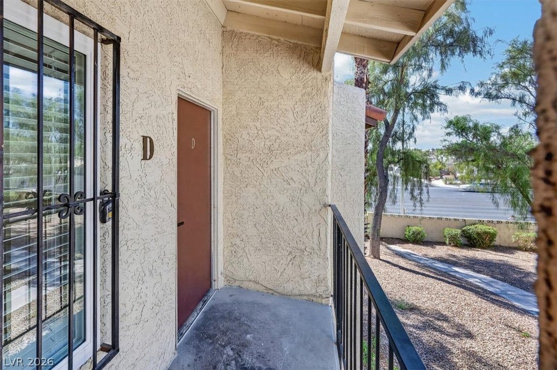 4454 W Desert Inn Road, #D, Las Vegas, NV 89102 A private upper-level entrance opens to a balcony overlooking the landscaped neighborhood surroundings.