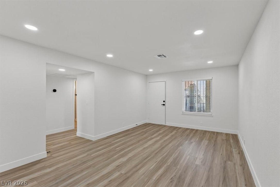 4454 W Desert Inn Road, #D, Las Vegas, NV 89102 Smooth wood-style flooring and recessed lighting define this versatile open living space.