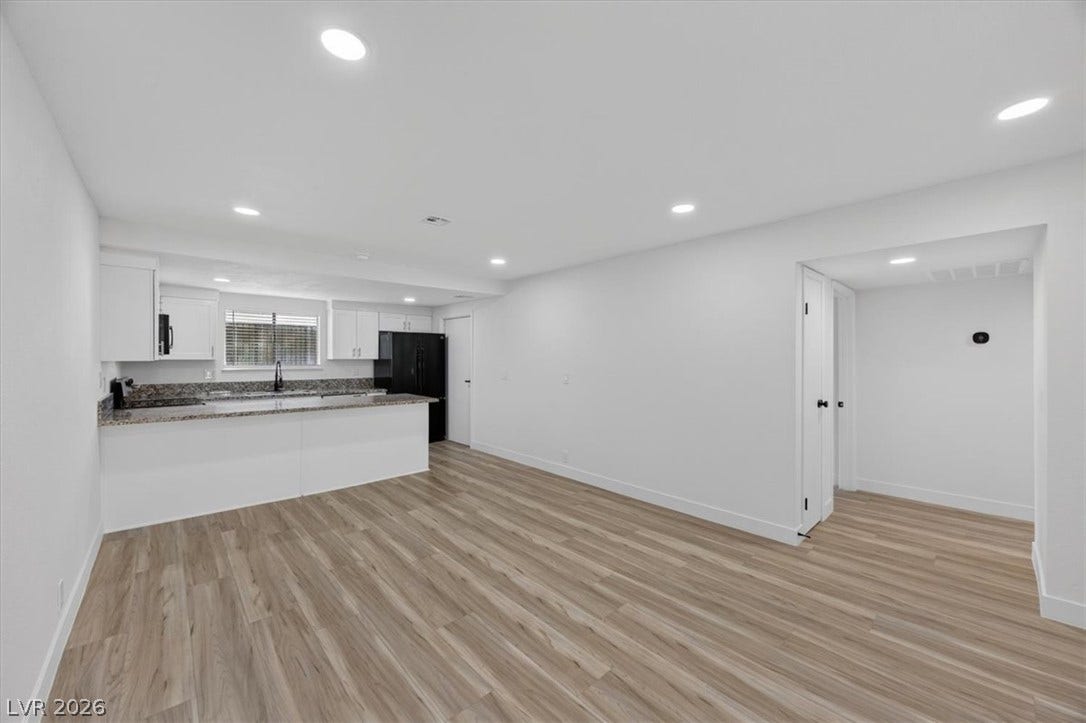 4454 W Desert Inn Road, #D, Las Vegas, NV 89102 Streamlined modern interiors unfold across a seamless open-plan layout finished with handsome wood-style flooring.