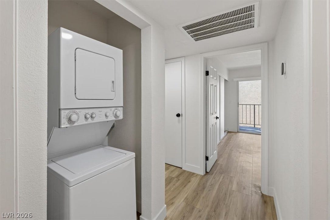 4454 W Desert Inn Road, #D, Las Vegas, NV 89102 An efficient laundry closet features wood-look flooring and adjacent access to a private balcony.