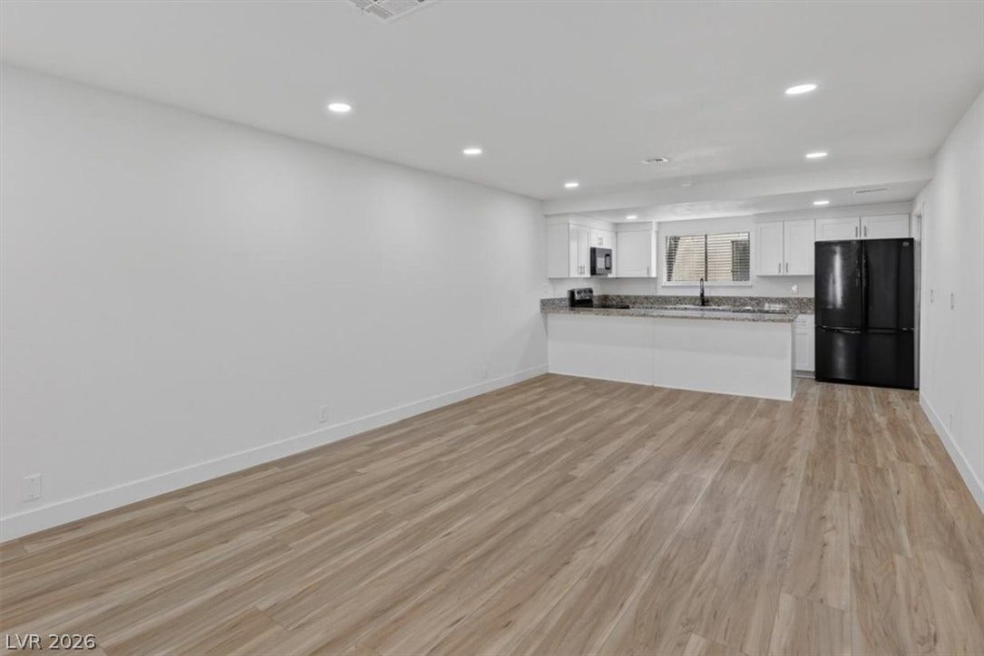 4454 W Desert Inn Road, #D, Las Vegas, NV 89102 Smooth wood-look flooring connects this spacious living area directly to the open kitchen.
