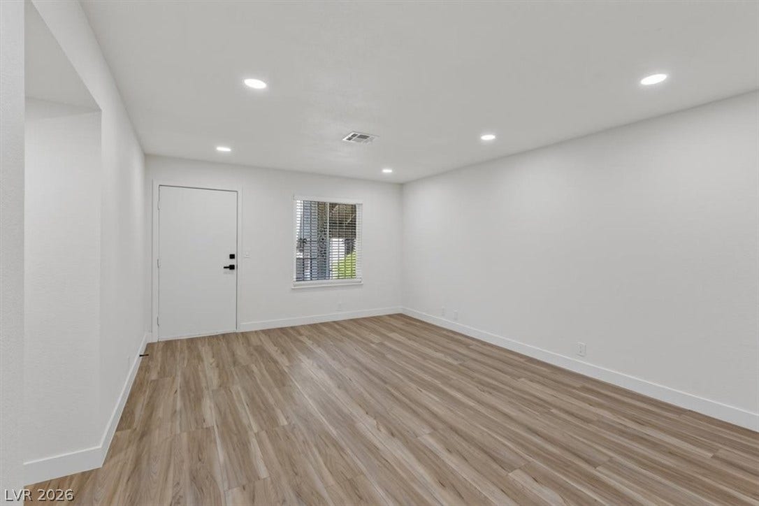 4454 W Desert Inn Road, #D, Las Vegas, NV 89102 Gleaming wood-look floors pair with crisp white walls and modern recessed lighting.