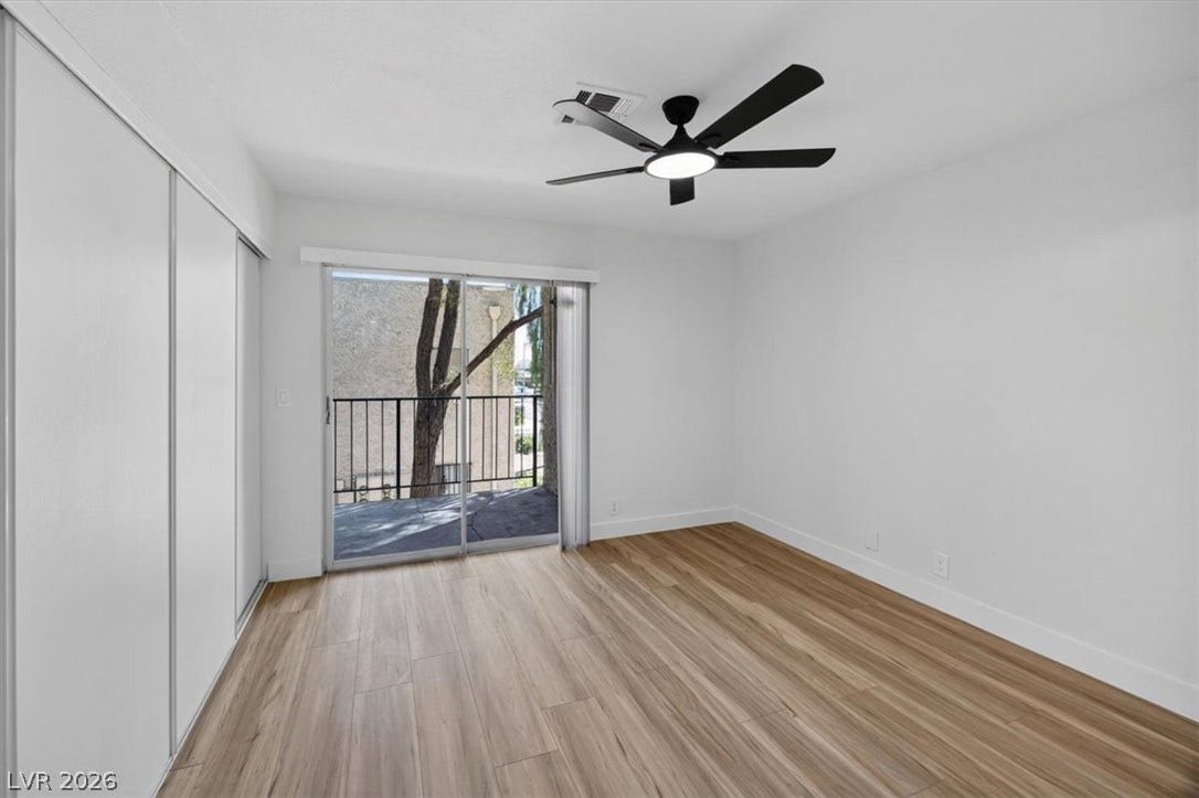 4454 W Desert Inn Road, #D, Las Vegas, NV 89102 Sliding glass doors open directly to a private balcony from this warm wood-floored space.