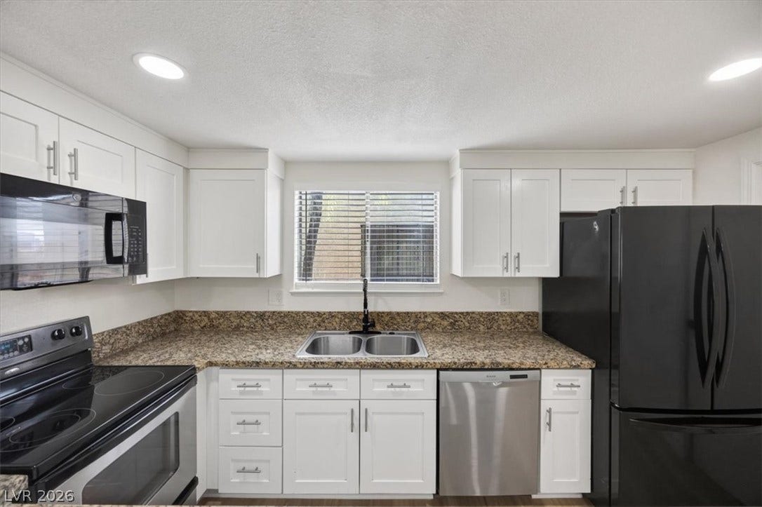 4454 W Desert Inn Road, #D, Las Vegas, NV 89102 Warm granite countertops and shaker cabinets create a highly functional workspace.