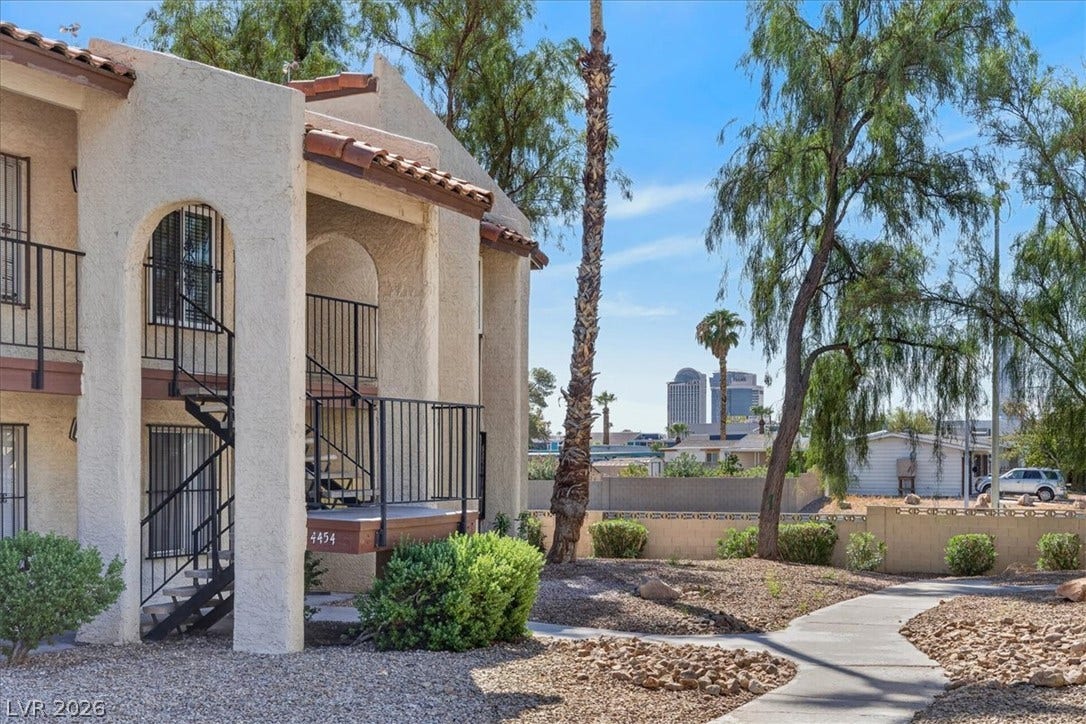 4454 W Desert Inn Road, #D, Las Vegas, NV 89102 Arched architectural details and low-maintenance desert landscaping frame this multi-level residential structure.