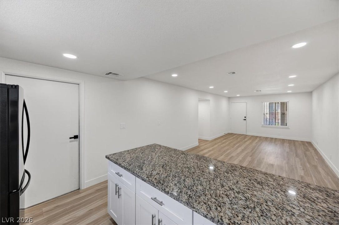 4454 W Desert Inn Road, #D, Las Vegas, NV 89102 Gleaming stone countertops and wood-look flooring anchors this modern open floorplan layout.