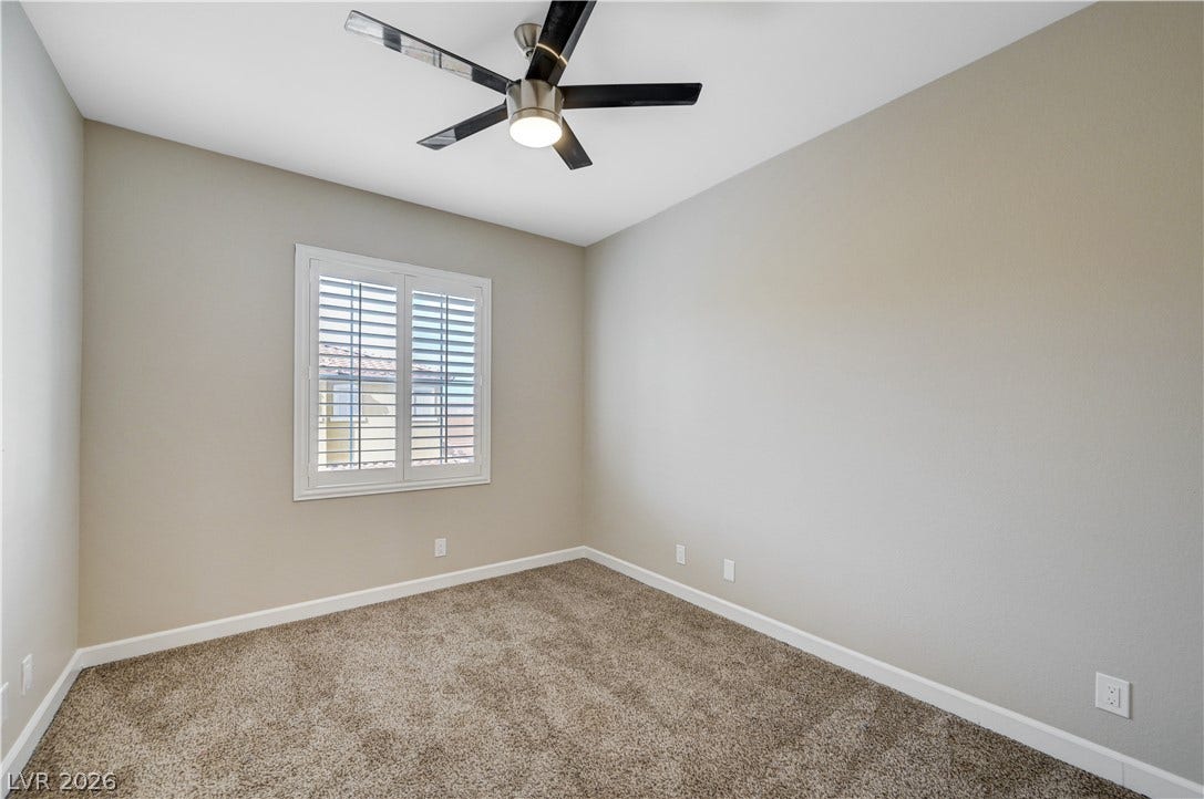 1525 Spiced Wine Avenue, #3105, Henderson, NV 89074 Plush carpeting and plantation shutters define this versatile secondary bedroom space.