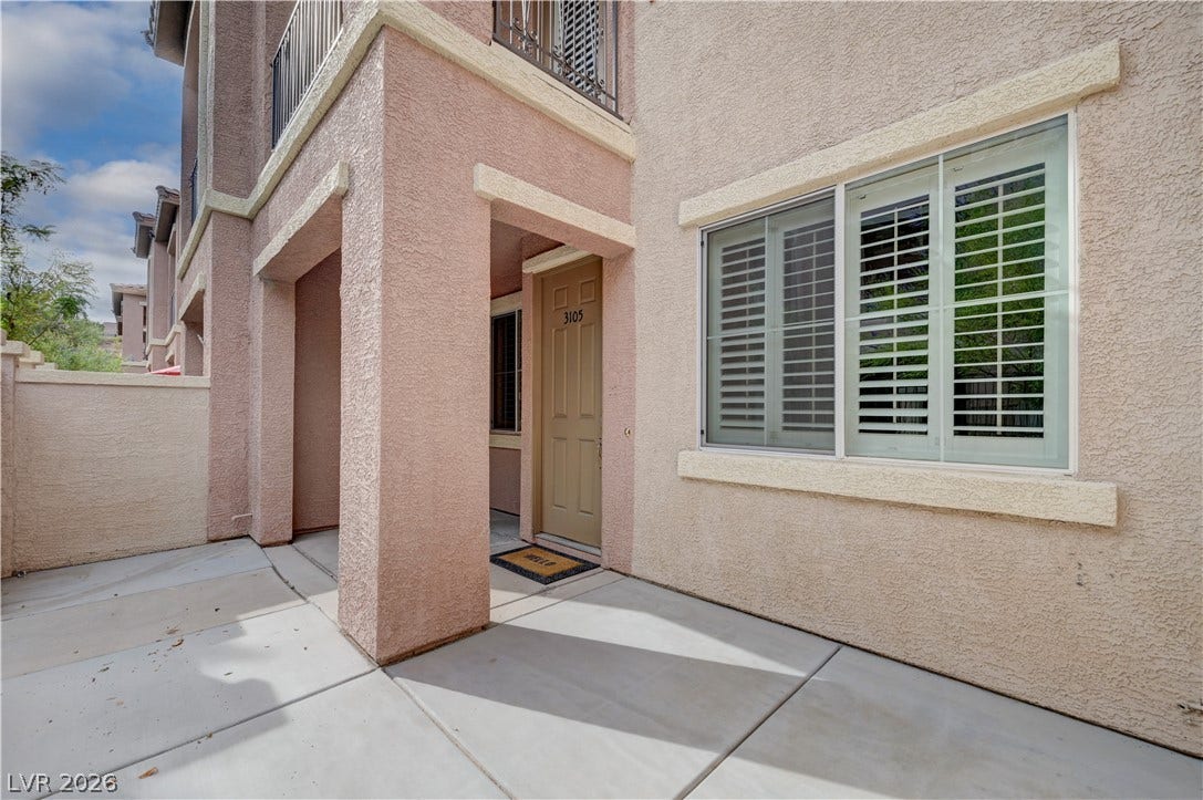 1525 Spiced Wine Avenue, #3105, Henderson, NV 89074 Textured stucco walls and concrete walkways define this modern multi-level exterior entryway.