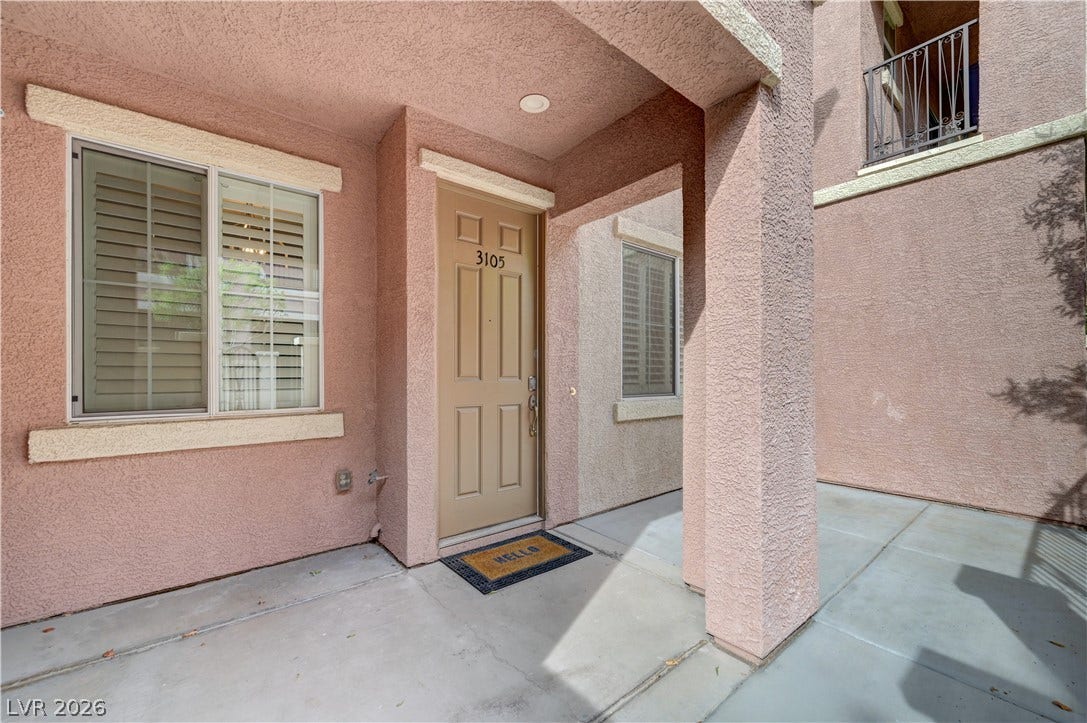 1525 Spiced Wine Avenue, #3105, Henderson, NV 89074 An inviting covered entryway features textured stucco walls and durable concrete flooring.