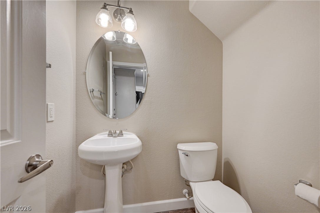 1525 Spiced Wine Avenue, #3105, Henderson, NV 89074 An elegant pedestal sink and oval mirror maximize space in this classic powder room.