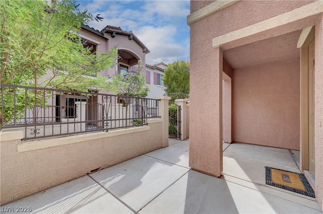 1525 Spiced Wine Avenue, #3105, Henderson, NV 89074 An inviting gated concrete patio leads directly to the private entrance of this stucco home.