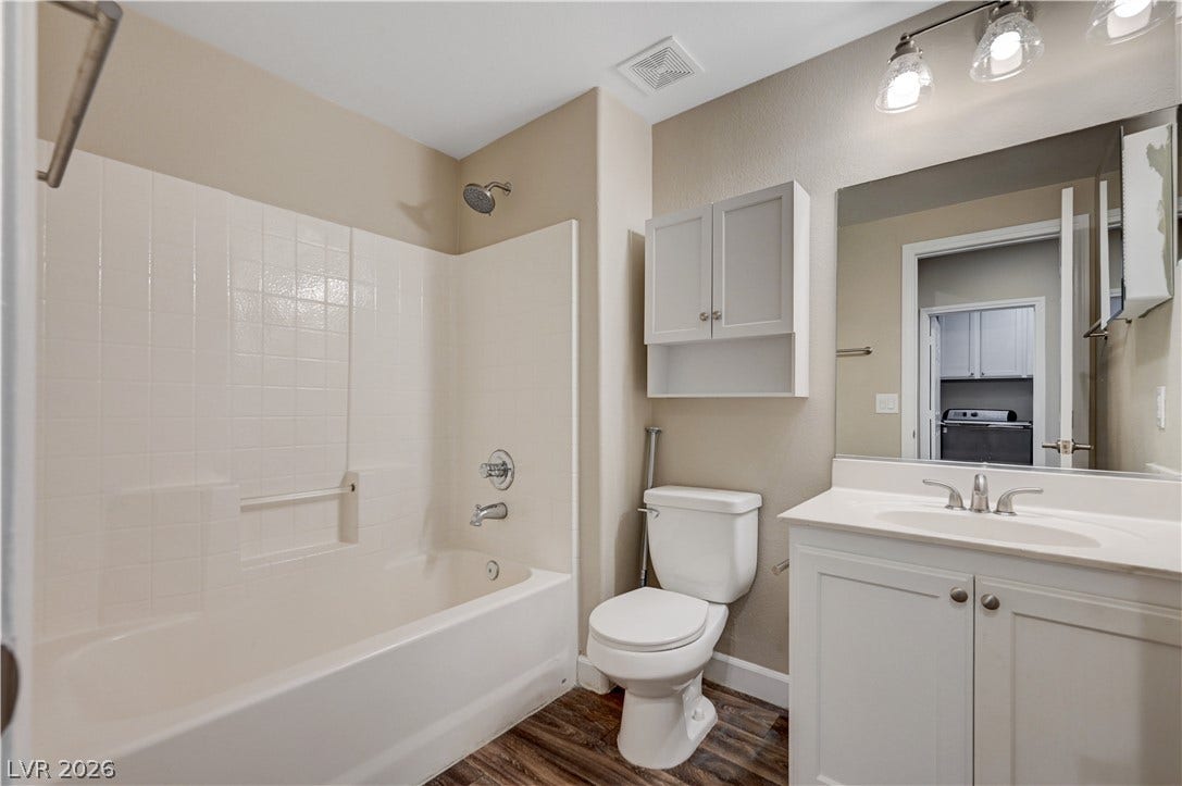 1525 Spiced Wine Avenue, #3105, Henderson, NV 89074 Clean modern finishes define this functional bathroom featuring a classic tub and vanity combo.