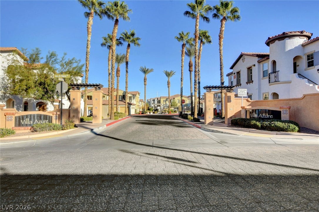 1525 Spiced Wine Avenue, #3105, Henderson, NV 89074 Palm trees frame the gated entrance to this Mediterranean-style residential community.