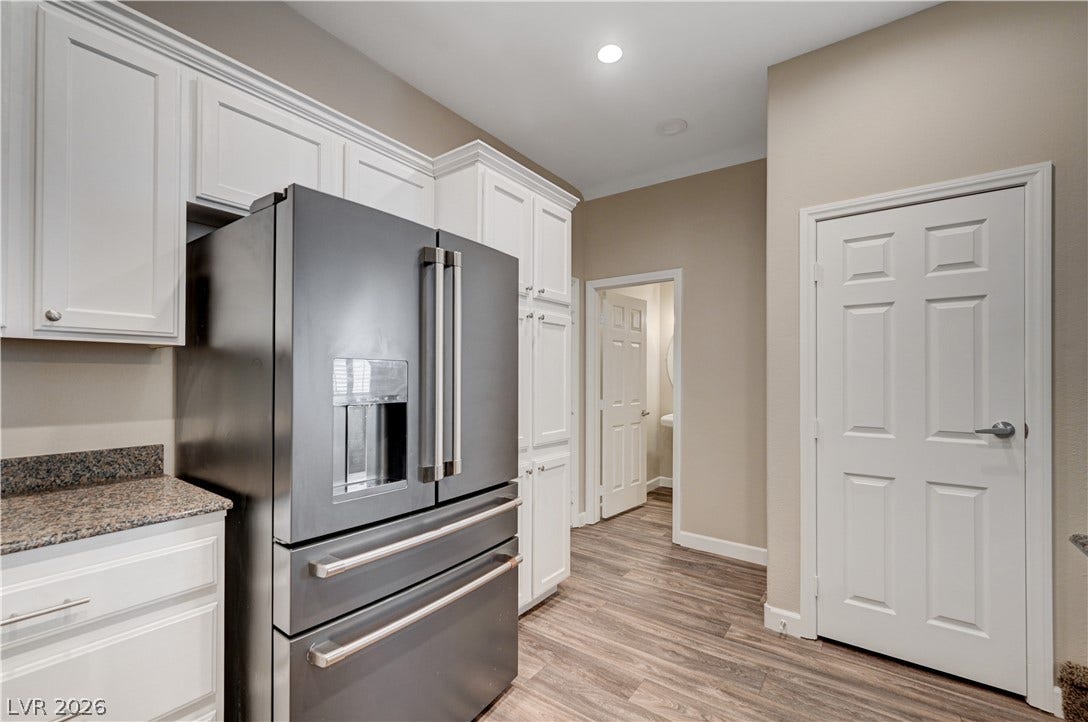 1525 Spiced Wine Avenue, #3105, Henderson, NV 89074 Premium cabinetry and modern stone countertops flank a generous built-in pantry alcove.