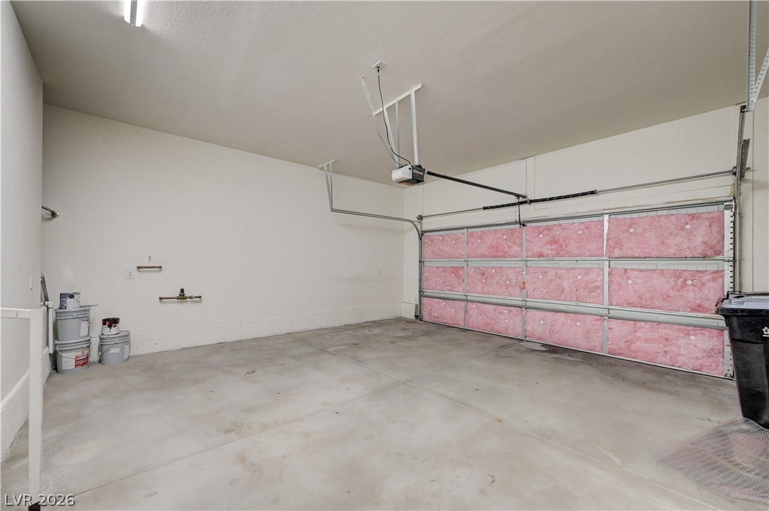 1525 Spiced Wine Avenue, #3105, Henderson, NV 89074 An attached two-car garage offers ample utility space and clean concrete flooring and door insulation.