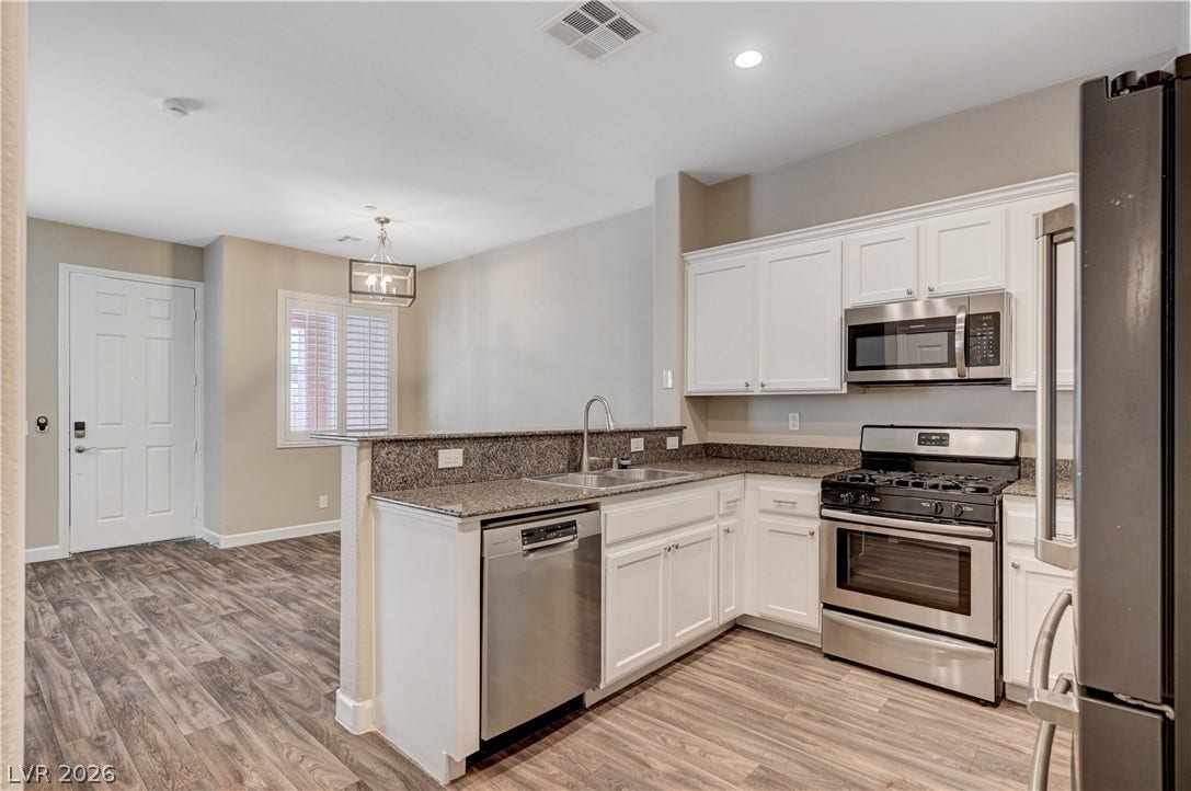 1525 Spiced Wine Avenue, #3105, Henderson, NV 89074 Seamless flow connects the cooking space to the dining area over polished stone countertops.
