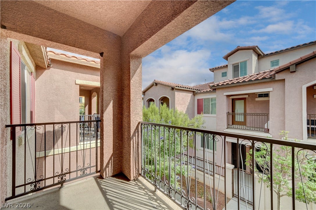 1525 Spiced Wine Avenue, #3105, Henderson, NV 89074 Off primary bedroom - wrought iron railings frame this covered concrete balcony overlooking the community.