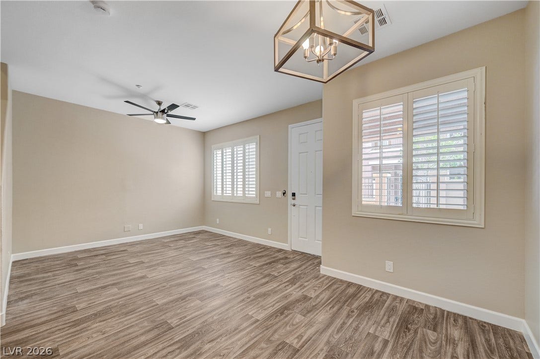 1525 Spiced Wine Avenue, #3105, Henderson, NV 89074 Rich wood-look flooring and crisp plantation shutters highlight this versatile open living area.