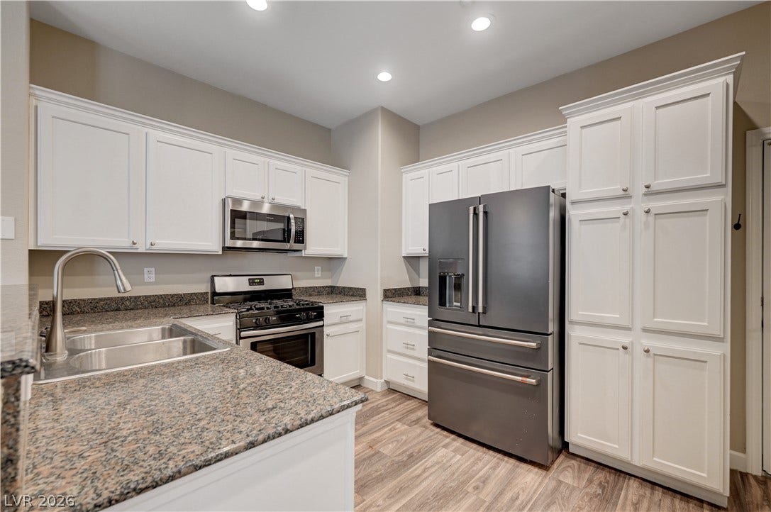 1525 Spiced Wine Avenue, #3105, Henderson, NV 89074 Rich granite countertops pair with classic cabinetry and sleek modern appliances in this space.