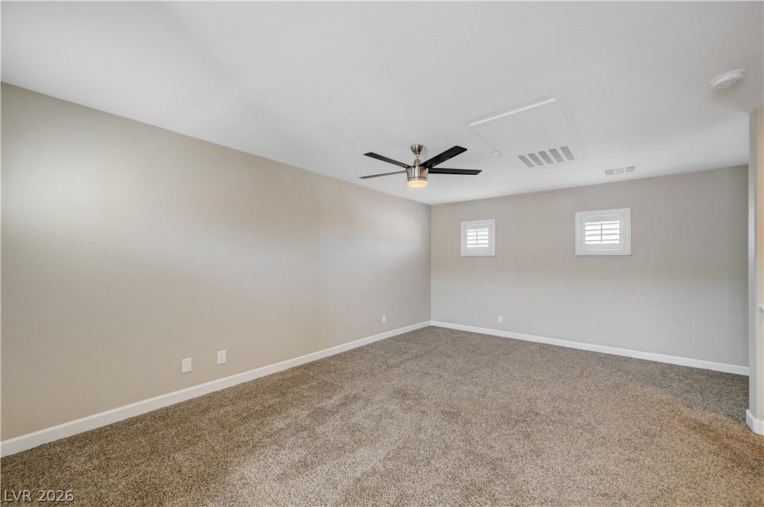 1525 Spiced Wine Avenue, #3105, Henderson, NV 89074 Plush carpeting anchors this versatile room detailed with dual windows and classic wall finishes.