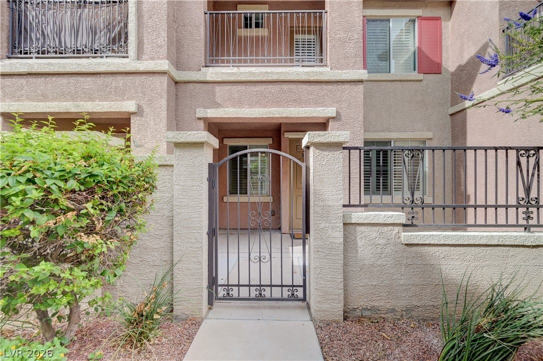 1525 Spiced Wine Avenue, #3105, Henderson, NV 89074 A gated entry path leads directly to the private stucco-clad exterior of this residence.