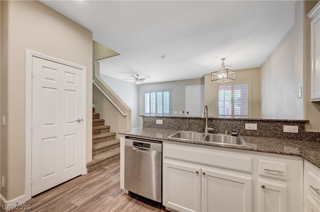 1525 Spiced Wine Avenue, #3105, Henderson, NV 89074 Granite countertops and wood-look flooring enrich this modern kitchen, which opens seamlessly to the living area.
