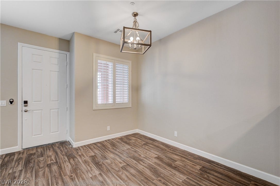 1525 Spiced Wine Avenue, #3105, Henderson, NV 89074 Gleaming wood-look floors anchor this welcoming entry space illuminated by a geometric chandelier.