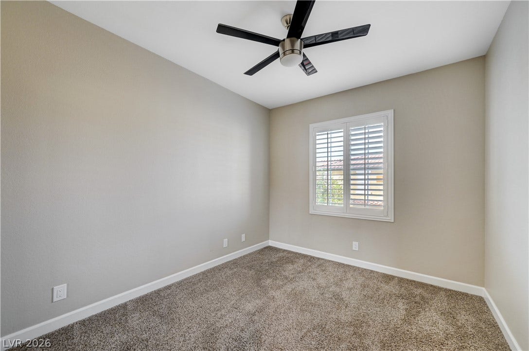 1525 Spiced Wine Avenue, #3105, Henderson, NV 89074 Plush carpeting and a classic plantation-shuttered window define this versatile space.