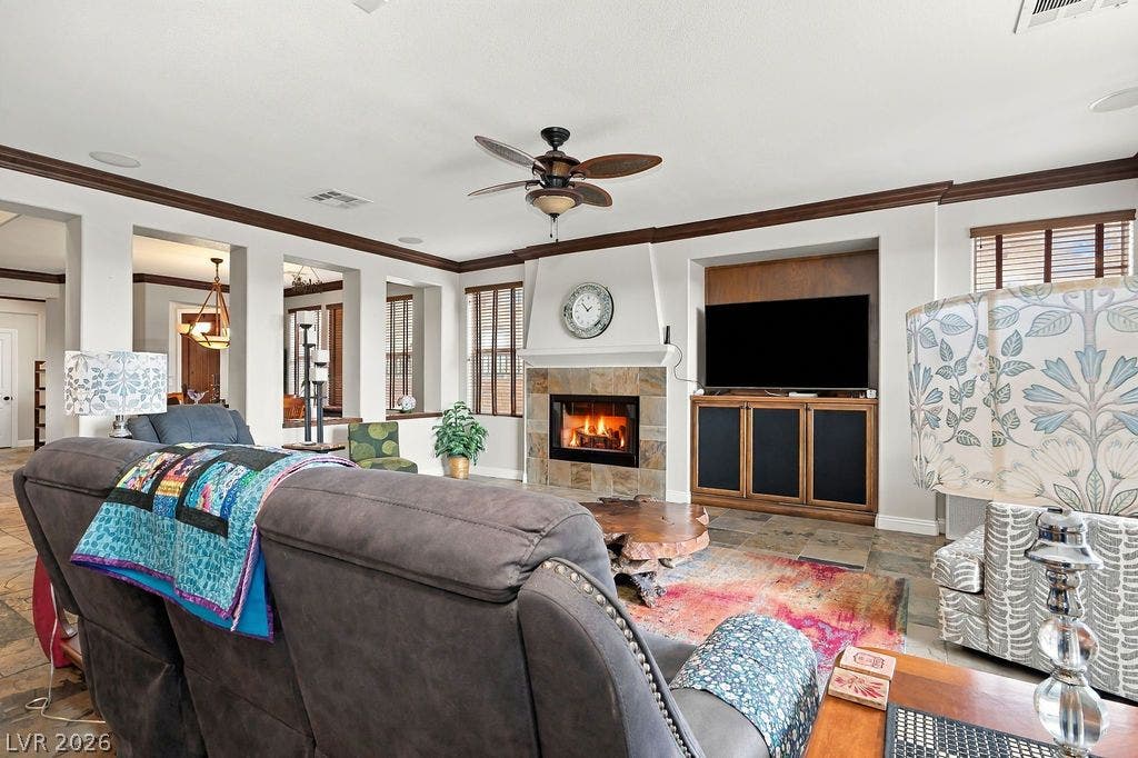 A stone-faced fireplace and built-in media cabinetry anchor this comfortable living space.