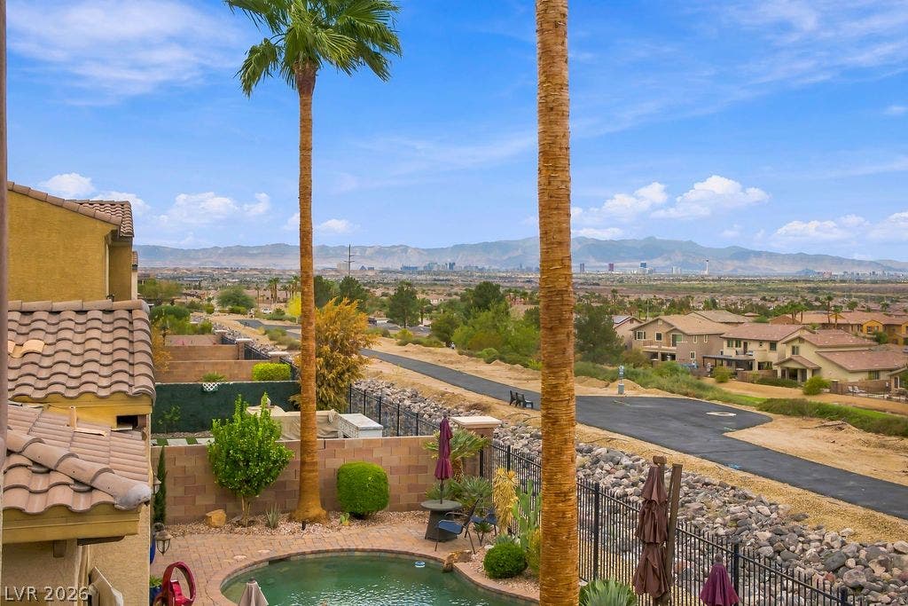 Sweeping views of the mountains and city skyline frame this backyard oasis.
