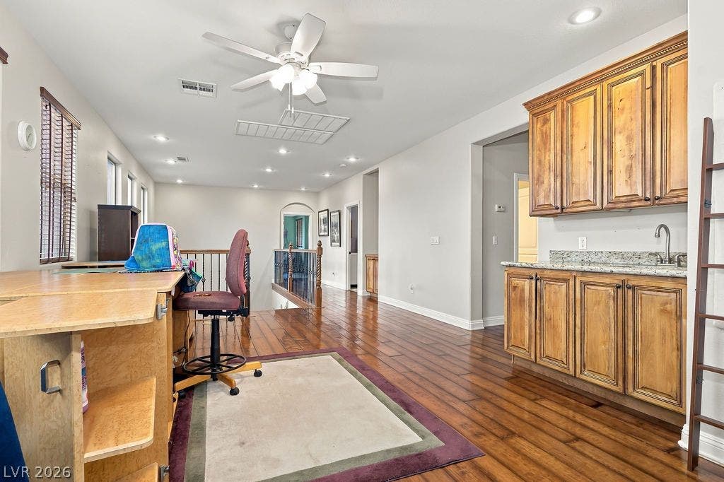 Gleaming hardwood floors and a built-in wet bar define this versatile upper-level loft space.