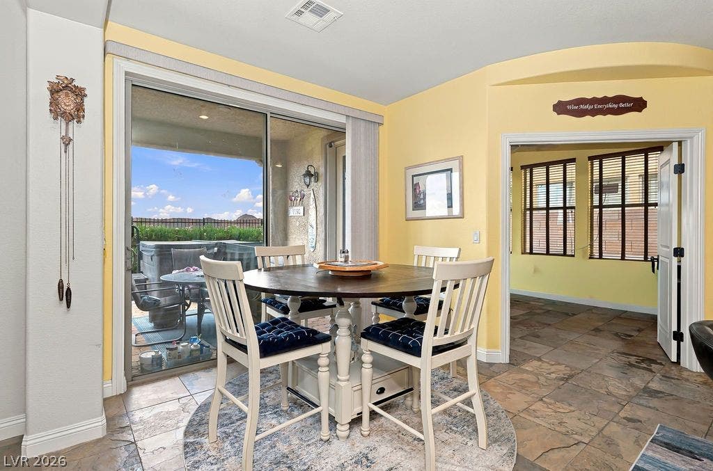 Sliding glass doors connect the casual dining space to a private backyard patio.