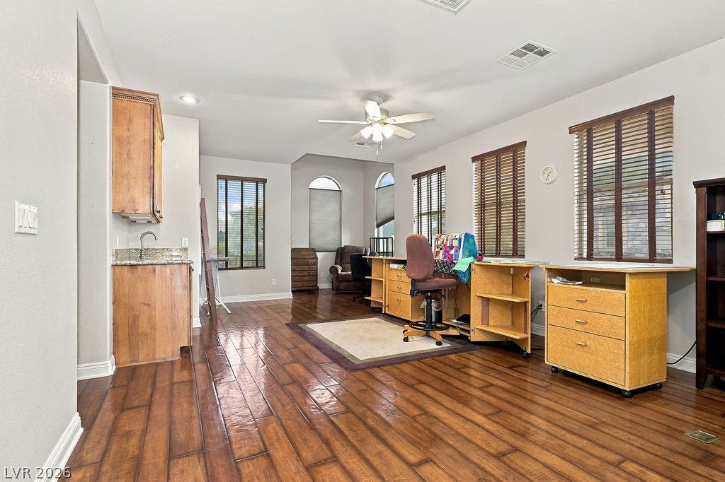 Gleaming hardwood floors and abundant natural light define this versatile, open living area.