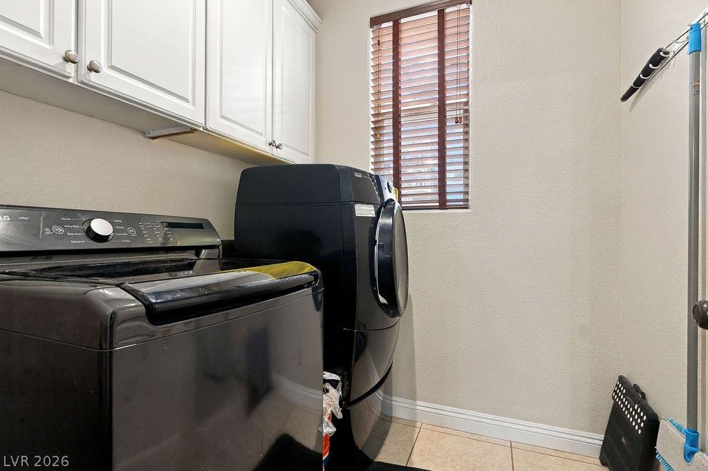 Crown molding and tiled floors complete this dedicated utility space.