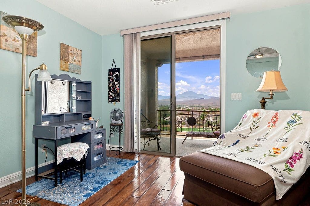 Hardwood floors and sliding glass doors framing mountain views elevate this tranquil space.