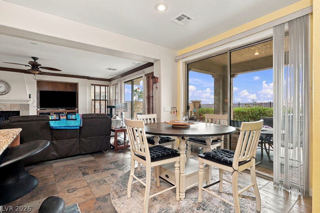 Natural light floods this dining area through wide sliding doors opening to the patio.