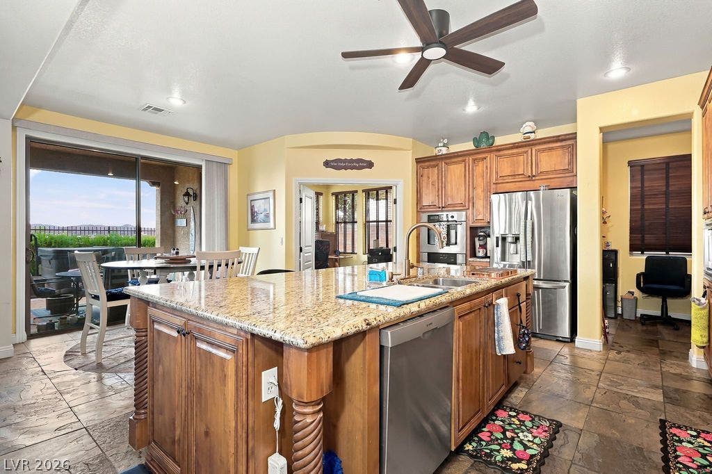 Granite counters and custom cabinetry anchor a spacious central kitchen island.