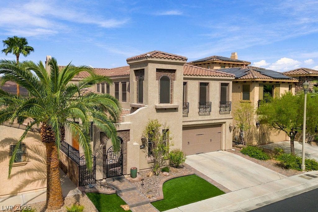 Mediterranean architectural details and a barrel tile roof define this multi-level facade.