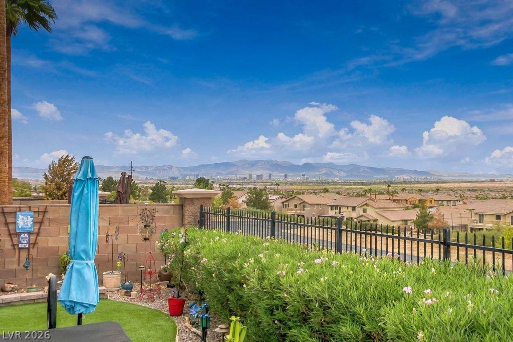 Panoramic mountain and distant skyline vistas unfold from this elevated backyard vantage point.