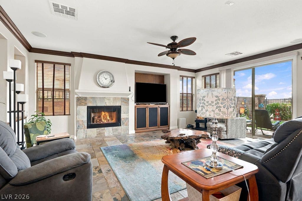 Rich tile flooring and a classic fireplace create a warm, welcoming ambiance in this living area.