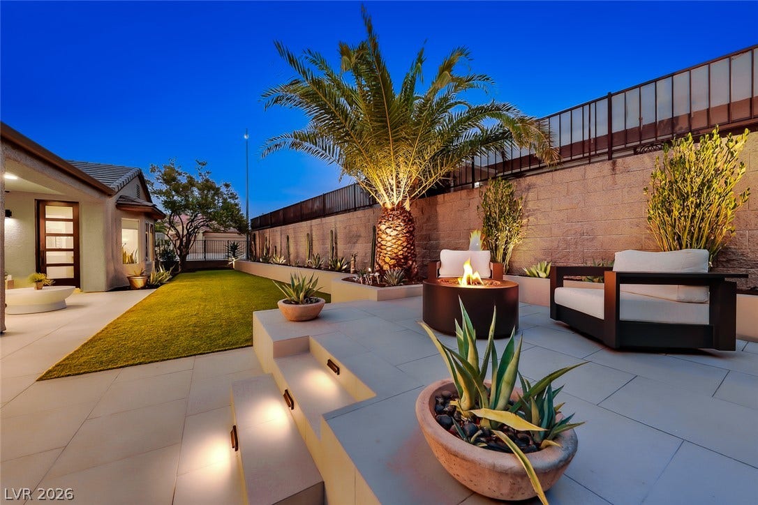 2601 Arimo Drive, Henderson, NV 89052 An inviting backyard patio integrates stone pavers, manicured turf, and integrated hardscape lighting.