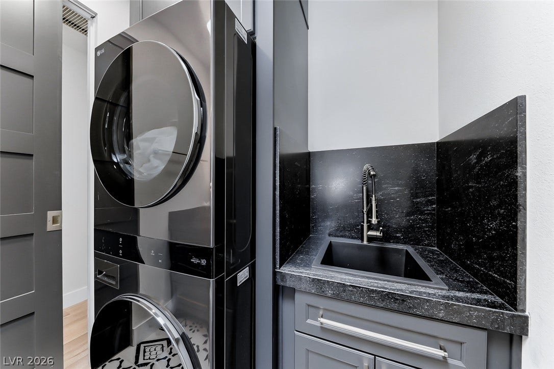 2601 Arimo Drive, Henderson, NV 89052 Custom cabinetry and premium stone counters surround this modern laundry setup.