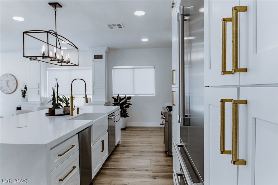 2601 Arimo Drive, Henderson, NV 89052 Gleaming stone countertops and warm wood floors define this bright culinary workspace.