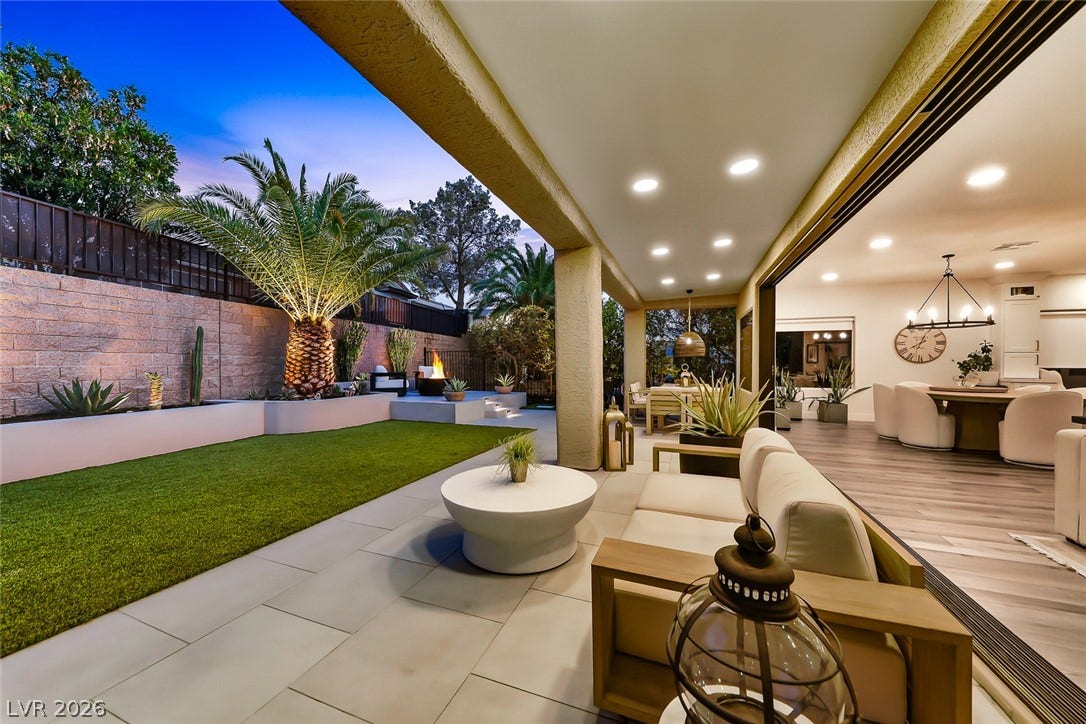 2601 Arimo Drive, Henderson, NV 89052 A spacious covered patio seamlessly transitions to a manicured lawn and private outdoor fireplace.
