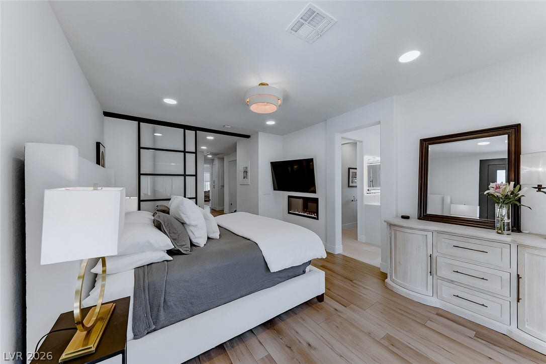 2601 Arimo Drive, Henderson, NV 89052 Recessed lighting and warm wood flooring enhance this modern sleeping space.