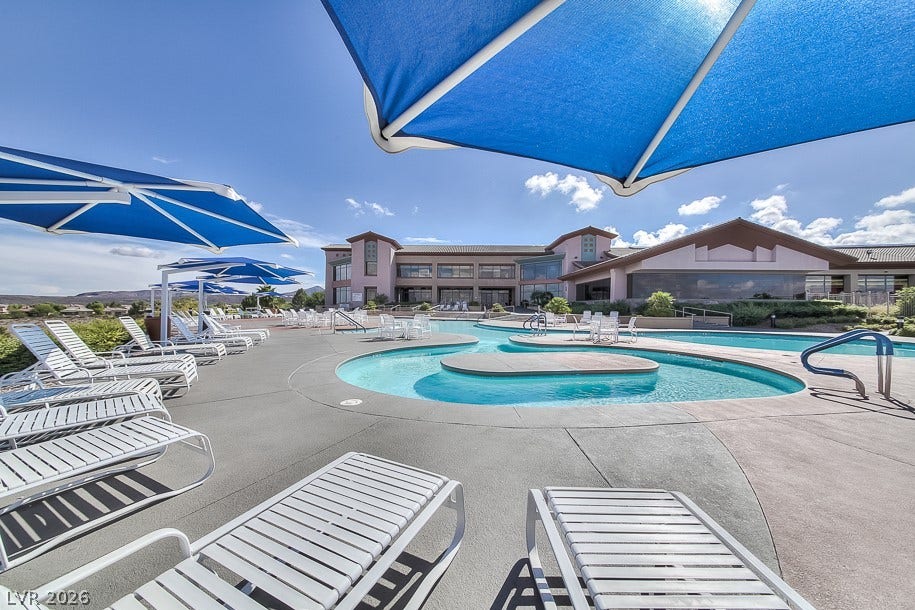 2601 Arimo Drive, Henderson, NV 89052 An inviting resort-style swimming pool area is surrounded by concrete decking and lounging spaces.
