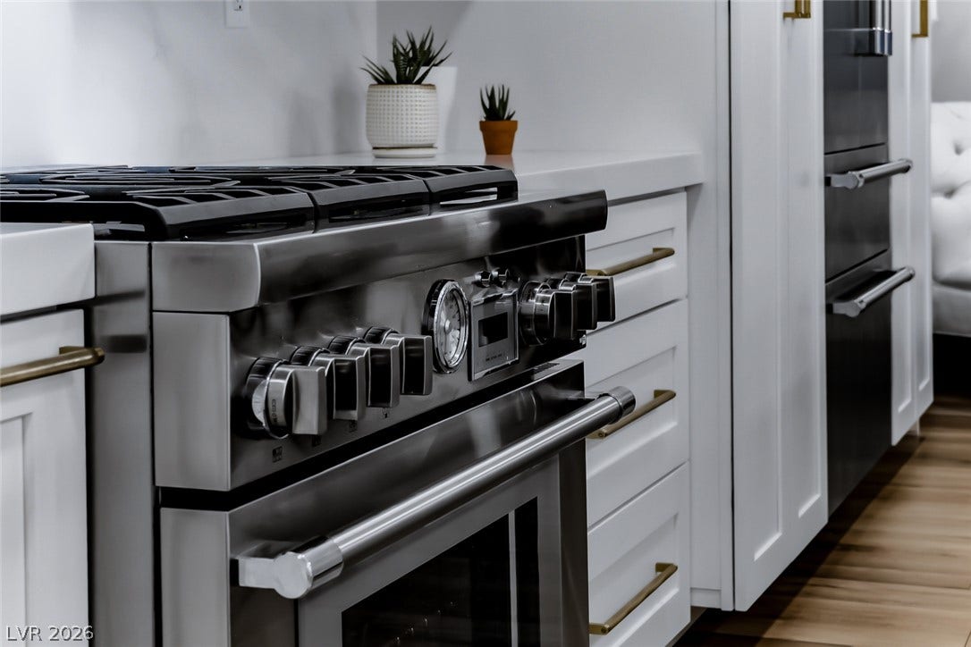 2601 Arimo Drive, Henderson, NV 89052 High-end stainless steel appliances pair seamlessly with crisp white cabinetry and solid surface countertops.